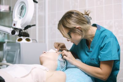 Beautician in a skin clinic with patient