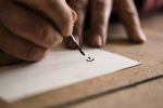 Person using a nib pen and ink to do calligraphy